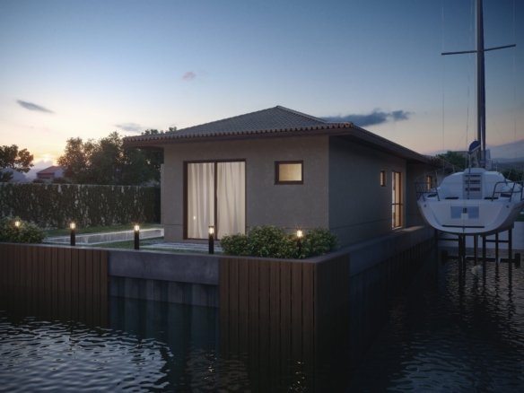 Casa tipo linear vista do canal, ao entardecer, com um veleiro ao lado, no Toriba (imagem ilustrativa)