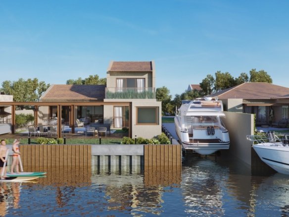 Casas tipo de frente para o canal, com lanchas atracadas e pessoas remando em pranchas, no Toriba (imagem ilustrativa)