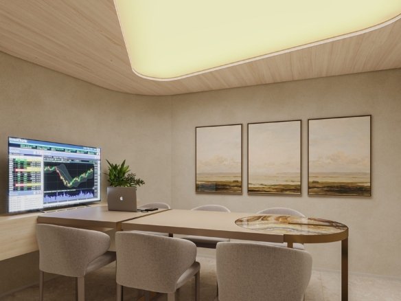 Sala de reunião com mesa alongada para seis lugares, cadeiras estofadas claras, monitores na parede e luminária de teto iluminada.