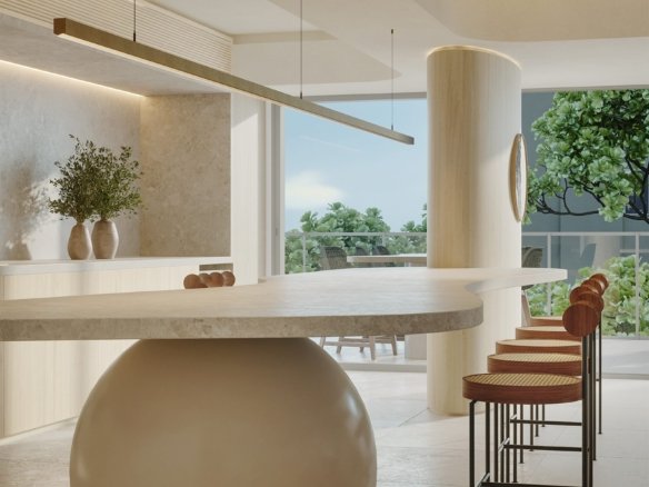 Bancada de pedra sobre base esférica, com banquetas de palhinha, luminária linear suspensa e vista para o terraço arborizado.